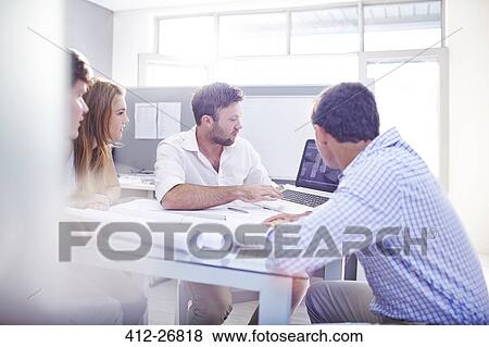 Architects drafting blueprints at laptop in office View Large Photo Image Stock Photo - Architects drafting blueprints at laptop in office. Fotosearch
