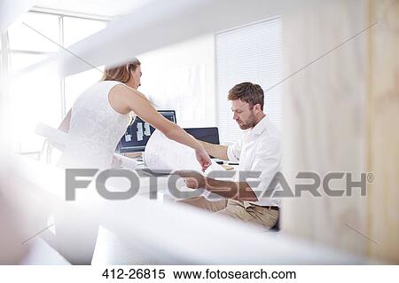 Architects reviewing blueprints in office View Large Photo Image Stock Photography - Architects reviewing blueprints in office. Fotosearch