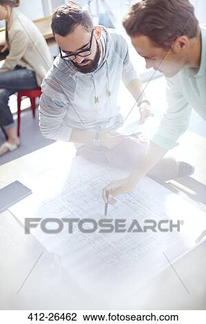 Architects reviewing blueprints View Large Photo Image Stock Image - Architects reviewing blueprints. Fotosearch