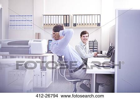 Architects talking at desk in office View Large Photo Image Picture - Architects talking at desk in office. Fotosearch