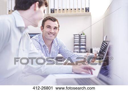 Architects with digital tablet talking in office View Large Photo Image Stock Image - Architects with digital tablet talking in office. Fotosearch