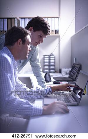 Architects working at laptop in office View Large Photo Image Stock Image - Architects working at laptop in office. Fotosearch