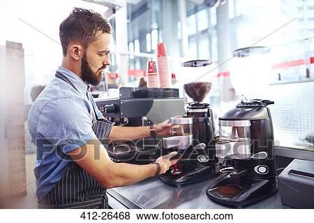 Stock Photo - Barista making coffee in cafe. Fotosearch