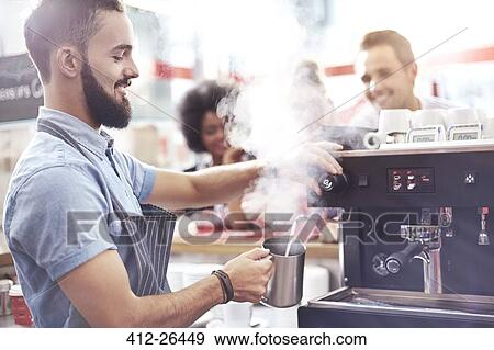 Barista steaming milk in cafe View Large Photo Image Stock Photo - Barista steaming milk in cafe. Fotosearch
