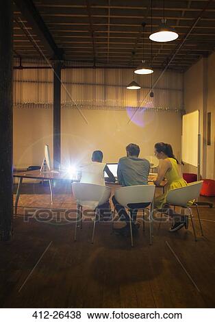 Business people at laptop preparing audio visual presentation View Large Photo Image Stock Photo - Business people at laptop preparing audio visual presentation. Fotosearch