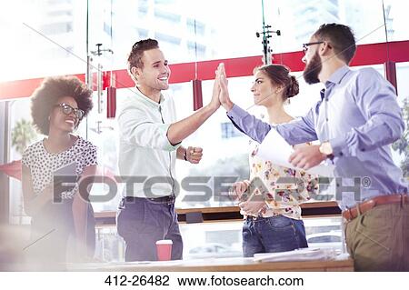Business people high fiving in meeting View Large Photo Image Stock Image - Business people high fiving in meeting. Fotosearch