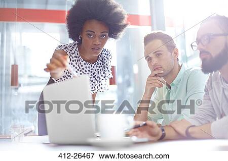 Business people meeting at laptop View Large Photo Image Stock Photo - Business people meeting at laptop. Fotosearch