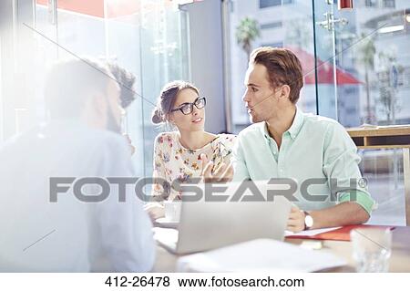 Business people meeting in sunny cafe View Large Photo Image Stock Photo - Business people meeting in sunny cafe. Fotosearch