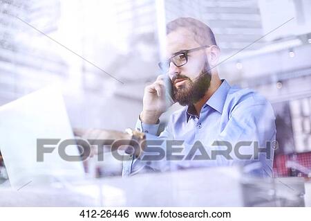 Businessman talking on cell phone and using laptop View Large Photo Image Stock Photograph - Businessman talking on cell phone and using laptop. Fotosearch