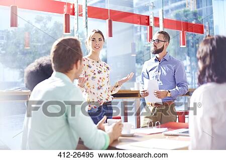 Businesswoman leading meeting in sunny office View Large Photo Image Stock Photography - Businesswoman leading meeting in sunny office. Fotosearch
