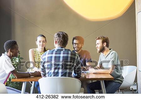 Casual business people meeting at table in office View Large Photo Image Stock Image - Casual business people meeting at table in office. Fotosearch