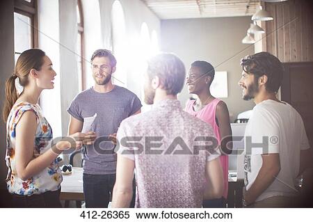 Stock Photography - Casual business people talking in office. Fotosearch
