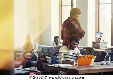 Stock Photo - Casual business people working in office. Fotosearch