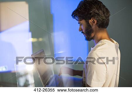 Casual businessman with laptop preparing audio visual presentation View Large Photo Image Stock Photography - Casual businessman with laptop preparing audio visual presentation. Fotosearch