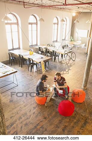 Picture - Casual businessmen meeting in open office. Fotosearch