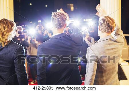 Celebrities waving and being photographed by paparazzi photographers at red carpet event View Large Photo Image Stock Photography - Celebrities waving and being photographed by paparazzi photographers at red carpet event. Fotosearch