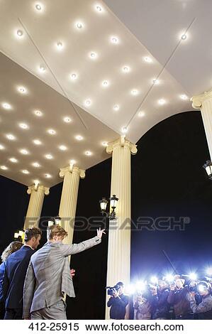 Celebrities waving at paparazzi photographers at event View Large Photo Image Stock Photography - Celebrities waving at paparazzi photographers at event. Fotosearch