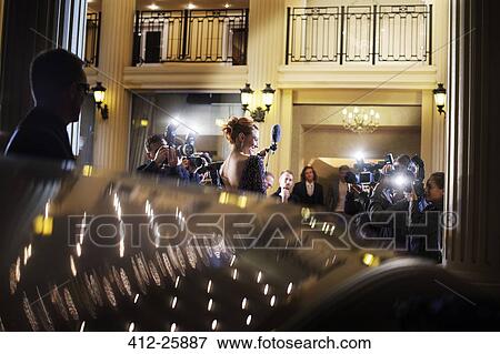 Stock Photo - Celebrity arriving at event and being photographed by paparazzi. Fotosearch