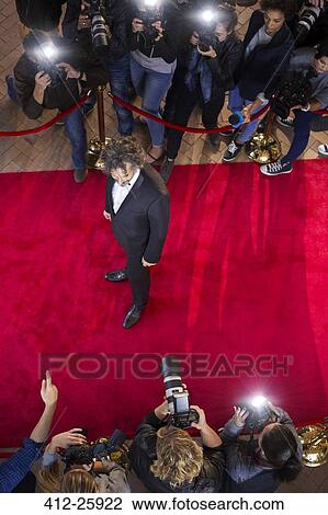 Celebrity being photographed by paparazzi photographers at red carpet event View Large Photo Image Stock Image - Celebrity being photographed by paparazzi photographers at red carpet event. Fotosearch
