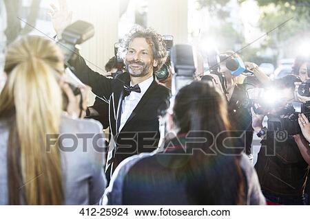 Celebrity waving at paparazzi photographers at event View Large Photo Image Picture - Celebrity waving at paparazzi photographers at event. Fotosearch