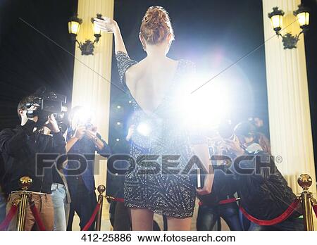 Celebrity waving to paparazzi photographers at red carpet event View Large Photo Image Stock Photograph - Celebrity waving to paparazzi photographers at red carpet event. Fotosearch