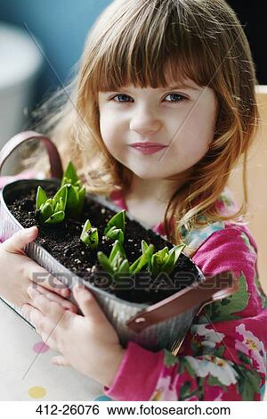 Close up portrait of girl holding sprouting flowers in basket View Large Photo Image Stock Photograph - Close up portrait of girl holding sprouting flowers in basket. Fotosearch
