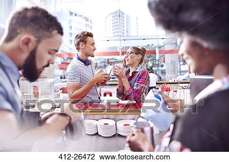 Couple talking and drinking coffee in cafe View Large Photo Image Stock Image - Couple talking and drinking coffee in cafe. Fotosearch