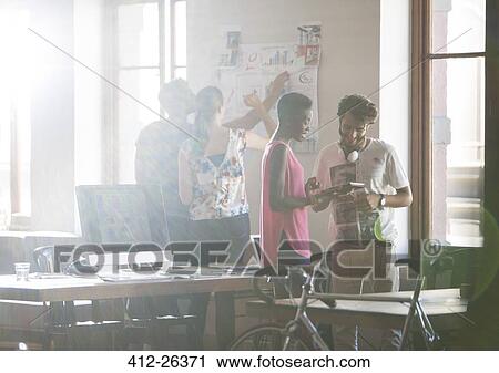 Creative business people brainstorming and working in office View Large Photo Image Stock Image - Creative business people brainstorming and working in office. Fotosearch