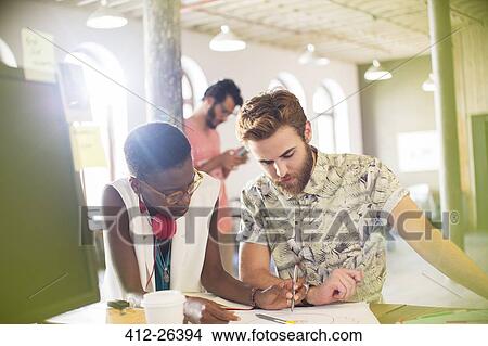 Picture - Creative business people drawing diagram in office. Fotosearch