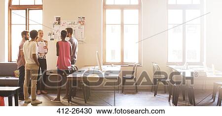 Stock Image - Creative business people meeting in sunny office. Fotosearch