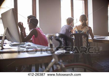 Creative business people working in open office plan View Large Photo Image Stock Photo - Creative business people working in open office plan. Fotosearch