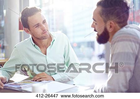 Stock Photo - Creative businessmen meeting in cafe. Fotosearch