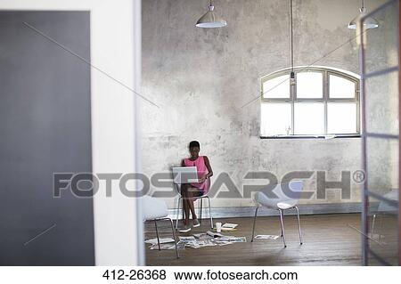 Stock Photo - Creative businesswoman working at laptop in modern office. Fotosearch