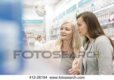 Customers shopping in pharmacy View Large Photo Image Picture - Customers shopping in pharmacy. Fotosearch