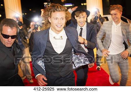 Enthusiastic celebrities arriving and running from paparazzi at red carpet event View Large Photo Image Stock Photography - Enthusiastic celebrities arriving and running from paparazzi at red carpet event. Fotosearch