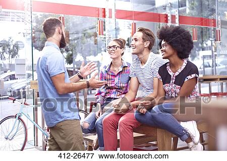 Friends talking and hanging out in cafe View Large Photo Image Stock Photo - Friends talking and hanging out in cafe. Fotosearch