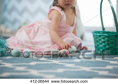 Girl in pink dress with Easter eggs View Large Photo Image Picture - Girl in pink dress with Easter eggs. Fotosearch