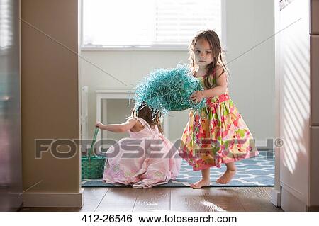 Stock Photograph - Girls in dresses with Easter baskets. Fotosearch