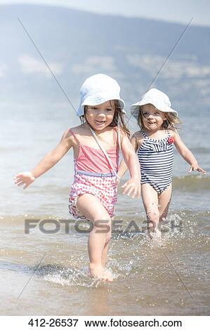 Girls wading in ocean View Large Photo Image Stock Photo - Girls wading in ocean. Fotosearch