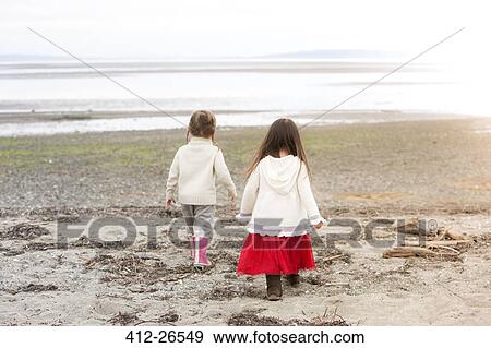 Girls walking on beach View Large Photo Image Stock Photo - Girls walking on beach. Fotosearch