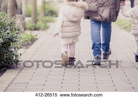Grandmother and granddaughters walking on stone path View Large Photo Image Stock Photography - Grandmother and granddaughters walking on stone path. Fotosearch