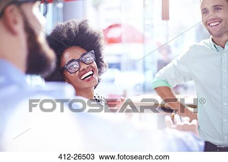Stock Image - Laughing businesswoman in meeting. Fotosearch