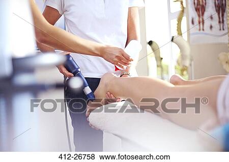Masseuse applying gel to woman’s leg in preparation for ultrasound probe View Large Photo Image Stock Photo - Masseuse applying gel to woman’s leg in preparation for ultrasound probe. Fotosearch