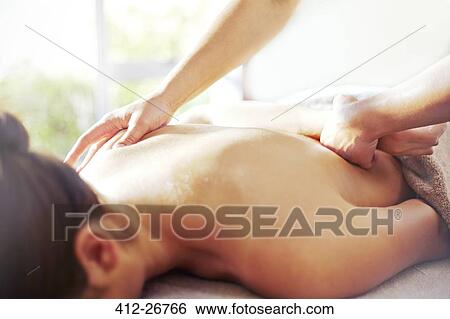 Masseuse massaging woman’s back View Large Photo Image Stock Photograph - Masseuse massaging woman’s back. Fotosearch