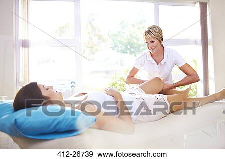 Masseuse massaging woman’s leg View Large Photo Image Stock Photo - Masseuse massaging woman’s leg. Fotosearch