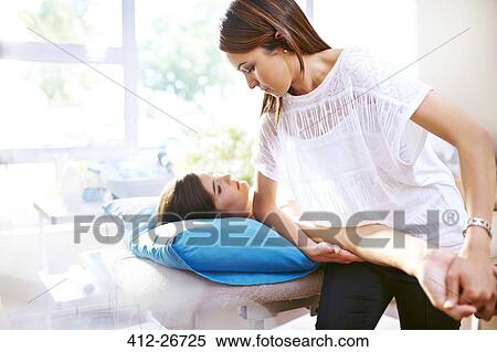 Masseuse stretching woman’s arm View Large Photo Image Stock Photography - Masseuse stretching woman’s arm. Fotosearch