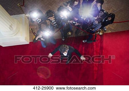Paparazzi photographers photographing celebrity at red carpet event View Large Photo Image Stock Image - Paparazzi photographers photographing celebrity at red carpet event. Fotosearch