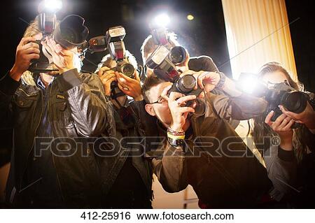 Paparazzi photographers photographing at event View Large Photo Image Stock Photograph - Paparazzi photographers photographing at event. Fotosearch