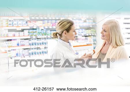 Pharmacist and customer talking in pharmacy View Large Photo Image Stock Photo - Pharmacist and customer talking in pharmacy. Fotosearch