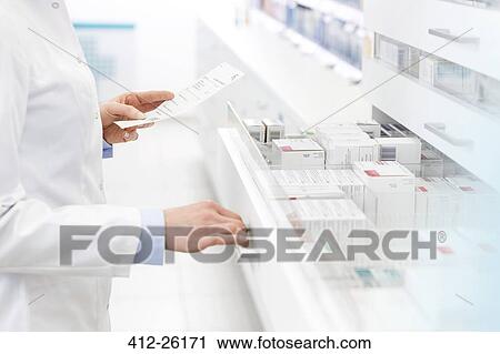 Stock Image - Pharmacist filling prescription in pharmacy. Fotosearch